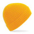 Introducing the BC380 by Beechfield, a vibrant yellow knit beanie featuring a ribbed texture. This beanie is showcased against a plain white background, emphasizing its bold color and minimalist design.
