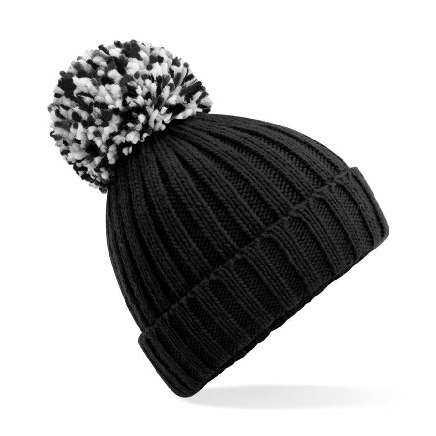 The Beechfield BC390 is a black knit beanie featuring a ribbed texture and adorned with a black-and-white pom-pom on top.