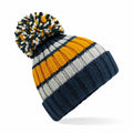 Introducing the BC392, a stylish winter hat from Beechfield featuring a knitted design with horizontal stripes in navy blue, yellow, and white, complete with a large multicolored pom-pom on top.