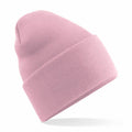 A Beechfield BC40R light pink knitted beanie hat with a folded cuff, floating against a plain white background.
