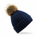 Introducing the Beechfield BC412 beanie, crafted in a sophisticated navy blue with a prominent fluffy brown pom-pom perched atop. This hat showcases a stylish ribbed texture and features a practical folded brim, all elegantly depicted against a crisp white background.
