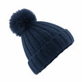The Beechfield BC413 is a dark blue beanie featuring a knitted design, ribbed texture, and adorned with a large, fluffy pom-pom on top.