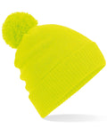 The Beechfield BC439 is a vibrant neon yellow beanie adorned with a pom-pom, showcased against a white background. It features a ribbed texture and lively color.