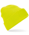 The BC440 beanie by Beechfield is a vibrant yellow knitted hat featuring a folded brim and a rectangular patch on the front. It is elegantly angled to highlight its texture and lively color.