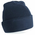 The Beechfield BC445 is a navy blue knit beanie featuring a folded brim and a rectangular patch on the front, designed for customization or branding.