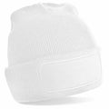 A white BC445 knitted beanie hat from Beechfield, featuring a blank rectangular patch on the front, is displayed against a plain white background.