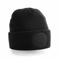 Beechfield BC446 black knit beanie featuring a folded brim and a circular patch on the front.