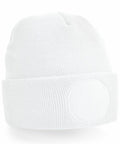 The BC446 beanie by Beechfield is a plain white knit hat with a ribbed texture and folded brim, featuring a subtle circular patch on the front. This design offers a simple and minimalist aesthetic.