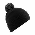 A Beechfield BC450 black knit beanie featuring a ribbed fold-over cuff and a black and white pom-pom on top, displayed against a plain white background.