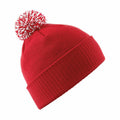 The Beechfield BC450 is a red knitted beanie featuring a white and red pom-pom on top.