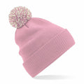 The Beechfield BC450 is a pink knit beanie featuring a large pom-pom on top, a folded brim, and a soft texture.