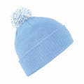 The BC450 by Beechfield is a light blue knit beanie featuring a ribbed fold-over cuff and a fluffy pom-pom on top.