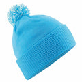 A Beechfield BC450 blue knit beanie featuring a pom-pom on top.