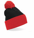 Beechfield BC451 black knit beanie with a red cuff and pom-pom, displayed on a white background.