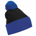 Product BC451 by Beechfield is a black beanie featuring a blue cuff and a matching blue pom-pom on top.