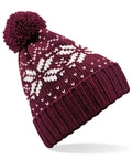 Beechfield's BC456 beanie in burgundy, featuring white snowflake patterns and a pom-pom.