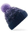 The Beechfield BC459 beanie in a knitted blue and purple design, featuring a pom-pom on top.