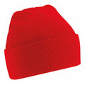 A Beechfield BC45B red knit beanie with a folded brim, displayed against a white background. The texture of the knit fabric is evident, providing it with a cozy look.