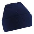 A Beechfield BC45B navy blue knit beanie with a folded brim, displayed against a white background. The texture of the knit fabric is evident, providing it with a cozy look.