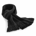 Beechfield BC470 black knitted scarf with fringed ends, coiled and laid on a white surface.