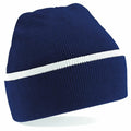 The Beechfield BC471 is a blue knit beanie featuring a white horizontal stripe around its middle.