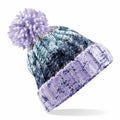 Introducing the BC486 by Beechfield: a knitted winter hat adorned with a purple pom-pom on top, showcasing a pattern in various shades of blue and purple and finished with a ribbed brim.