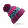 Introducing the Beechfield BC486, a vibrant winter hat boasting pink, purple, and teal patterns. The design is completed with a large purple pom-pom on top. Crafted from thick yarn, this knitted hat features a folded brim to ensure extra warmth during chilly days.