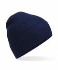 A Beechfield BC51N navy blue knitted beanie hat with a folded brim set against a white background.