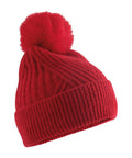 A red beanie knit hat features a wide ribbed turn-up brim and a large matching bobble on top, displayed against a plain white background.