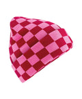 A beanie hat featuring a pink and red chequered pattern is displayed against a white background.