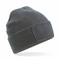 A Beechfield BC540 gray knitted beanie featuring a rectangular patch on the front.