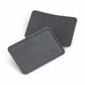 Displayed are two black rectangular patches from Beechfield's BC600 collection. One patch is positioned flat, while the other leans against it, both featuring a textured, looped surface typical of hook-and-loop fasteners used for attaching patches or securing items.