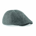 BC622, a gray tweed flat cap from Beechfield, is displayed from the side to highlight its herringbone pattern and rounded brim.