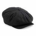 A Beechfield BC624 black flat cap, featuring a round crown and short brim, is displayed against a white background.
