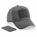 Beechfield's BC638 is a gray baseball cap featuring a Velcro patch on the front, accompanied by an additional black Velcro patch.