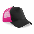 The Beechfield BC640 features a black front and brim with a stylish pink mesh back. This trucker cap offers a classic design with a curved peak.