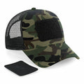 Beechfield BC641 camouflage baseball cap featuring a mesh back and a black Velcro patch on the front, with an extra black Velcro patch displayed next to it.