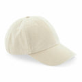 The Beechfield BC655 is a beige baseball cap featuring a curved brim and eyelets for ventilation, boasting a simple and unadorned design.