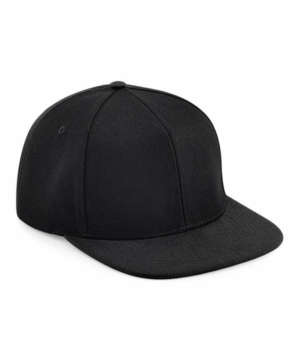 A black, flat-brim BC661 by Beechfield is shown in a three-quarter view. The hat is plain with no visible logos, designs, or embellishments. It features a classic six-panel construction with a small button on top, and the brim appears slightly textured.