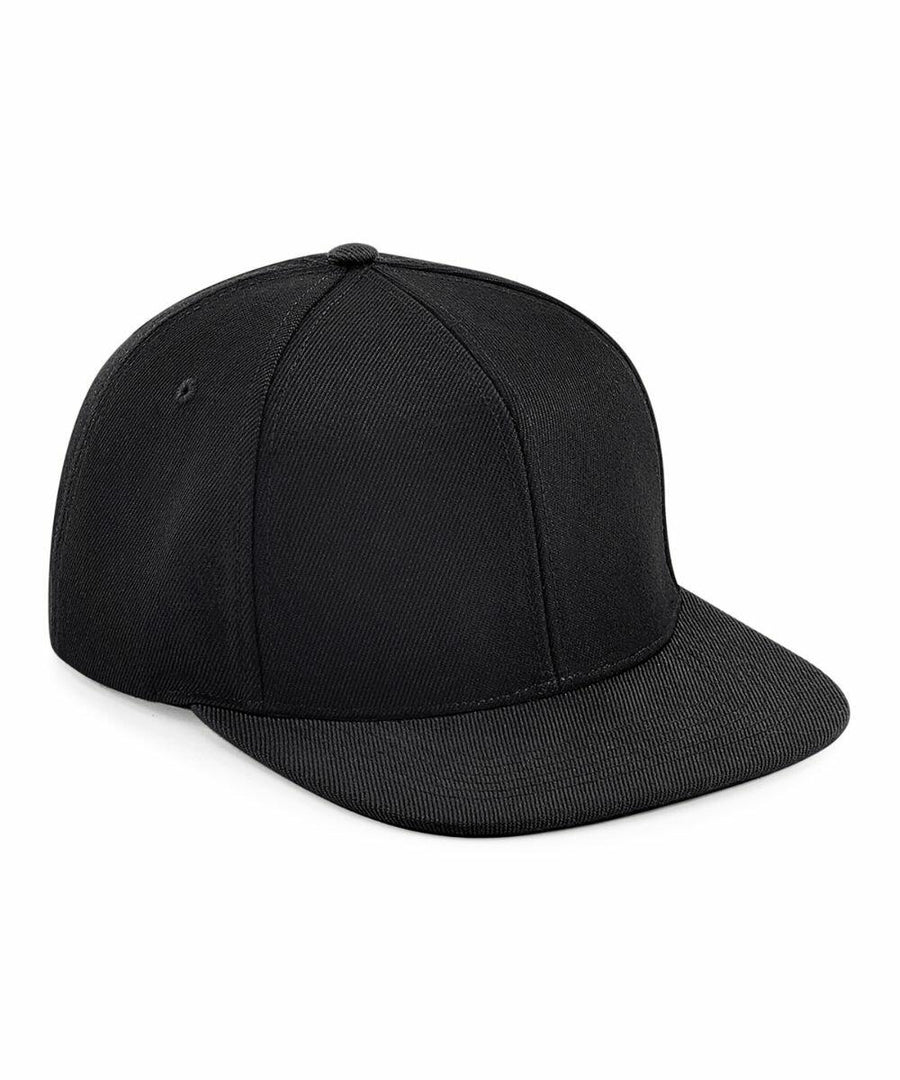 A black, flat-brim BC661 by Beechfield is shown in a three-quarter view. The hat is plain with no visible logos, designs, or embellishments. It features a classic six-panel construction with a small button on top, and the brim appears slightly textured.