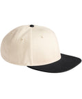 A beige Caps baseball cap with a black flat peak and black top button, displayed from a side angle on a white background.