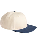 A beige Caps baseball cap with a navy blue flat peak and matching navy blue button on top, shown at a slight angle against a white background.