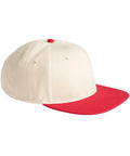 A cream-coloured Caps baseball cap with a red peak and top button is displayed from a side angle on a white background.