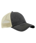 The Caps is a black and beige trucker hat featuring a black fabric front, beige mesh back panels, a curved peak, and visible white stitching.
