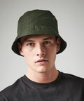 A man wearing a dark green Beechfield BC84R and a black shirt looks directly at the camera against a plain background.