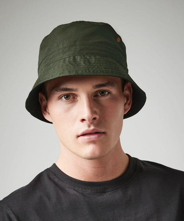 A man wearing a dark green Beechfield BC84R and a black shirt looks directly at the camera against a plain background.