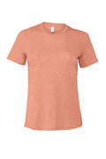 The Bella + Canvas BE046 is a plain, peach-colored short-sleeve T-shirt against a white background. It features a simple crew neck design and looks to be made from a soft, comfortable material.