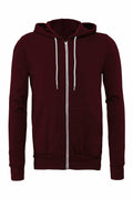 The Bella + Canvas BE106 is a maroon zip-up hoodie designed with a hood and white drawstrings. It includes two front pockets and is showcased against a plain white background.