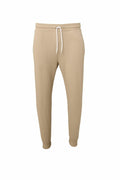 Bella + Canvas BE126 jogger pants in beige, featuring a drawstring waistband and cuffed ankles, displayed on a white background. The pants present a clean look with no visible logos or designs.