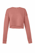 A long-sleeved, cropped sweatshirt in a dusty rose color from Bella + Canvas. The BE221 top features a simple, loose fit with ribbed cuffs and a crew neckline.